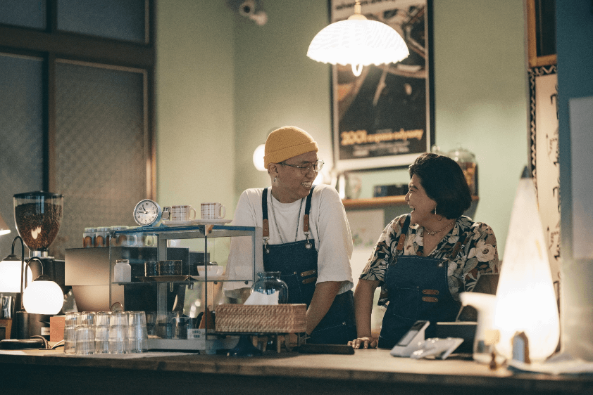 Two baristas in a coffee shop