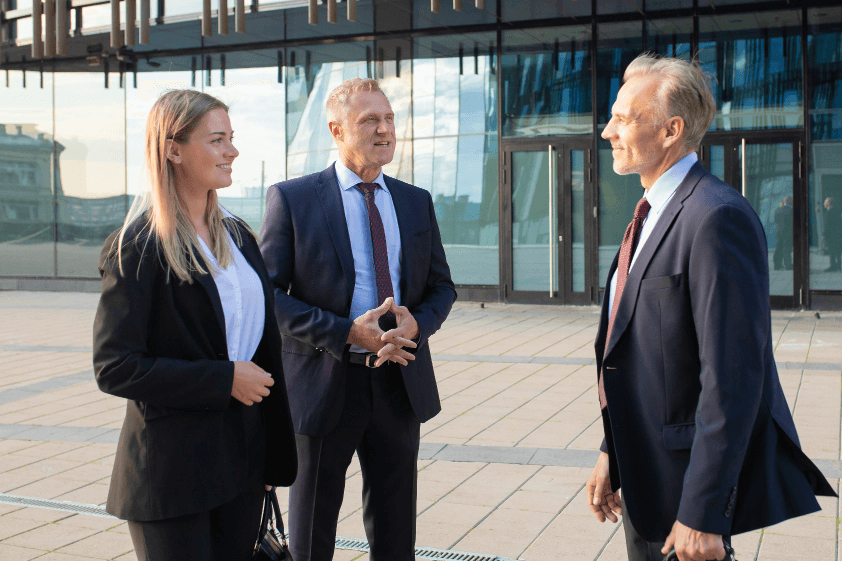Three business people outside of a building