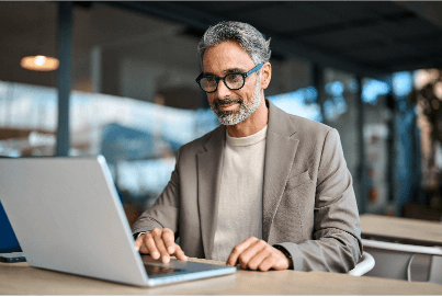 Distinguished man working on a laptop