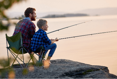 Father and son fishing on a dock