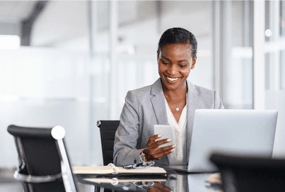 African American business woman looking at her phone and smiling